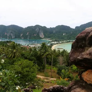 Traditional Thai longtail boats on the beach at Phi Phi Islands with limestone cliffs and turquoise water