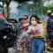 People spraying water and enjoying the Songkran Water Festival in Thailand with water guns and laughter.