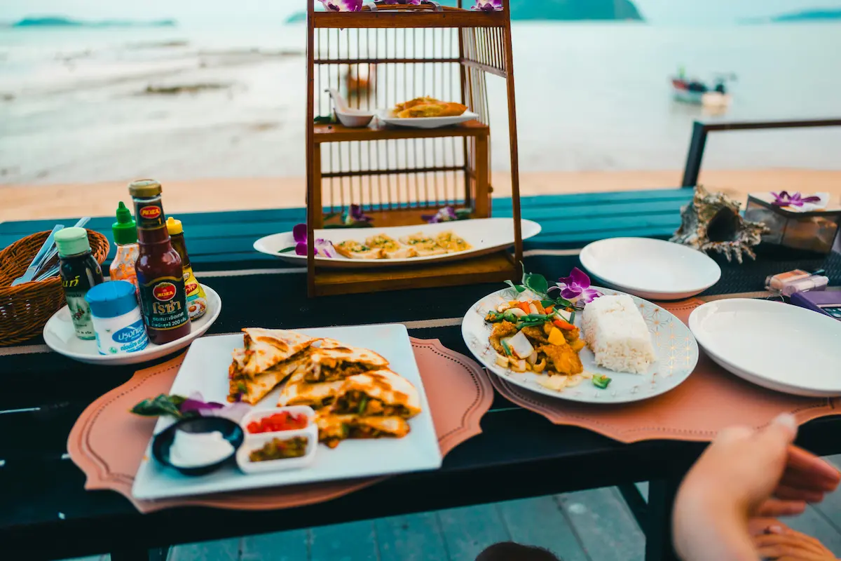 Sea-view Thai dinner in Phuket — curry, rice and shared plates at sunset