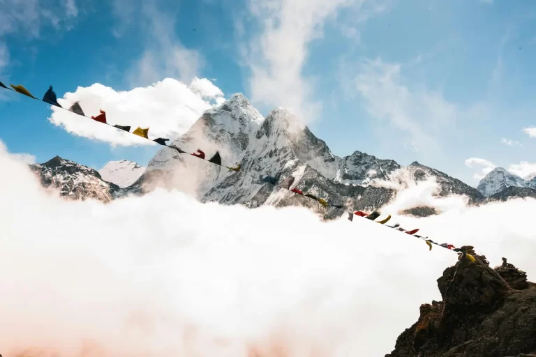 Prayer flags with Himalayan peaks at sunrise — classic Nepal trekking scene