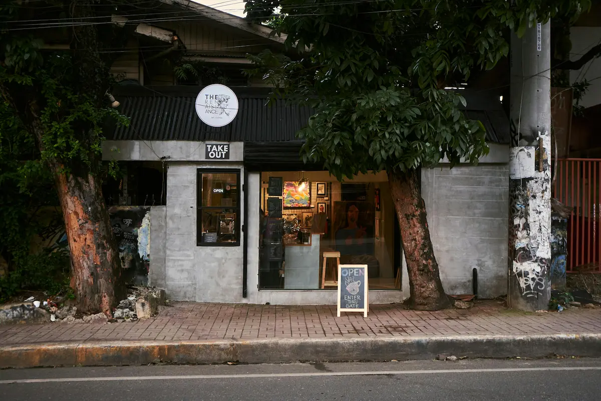 Street-level café and takeaway storefront showing everyday local rhythm when understanding what makes a place feel like it does